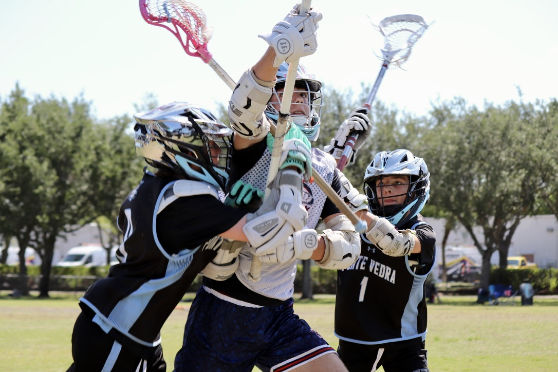 Boys Jaws player fighting through pressure near the goal