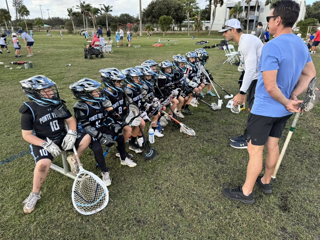 Young Boys Jaws players listening to their coaches on the sideline
