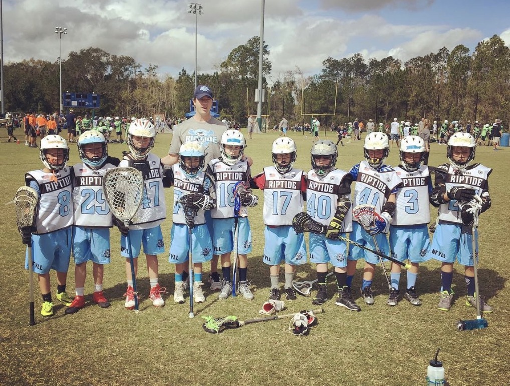 Boys Riptide team with their coach after a game